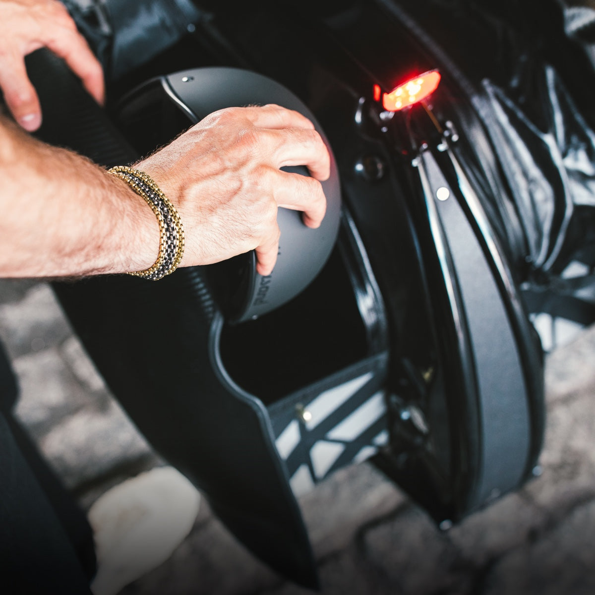 Placing a helmet in the expandable panniers.