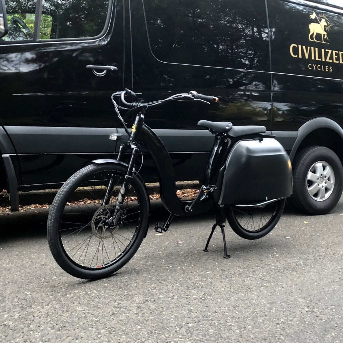 A Civ parked in front of our black branded van.